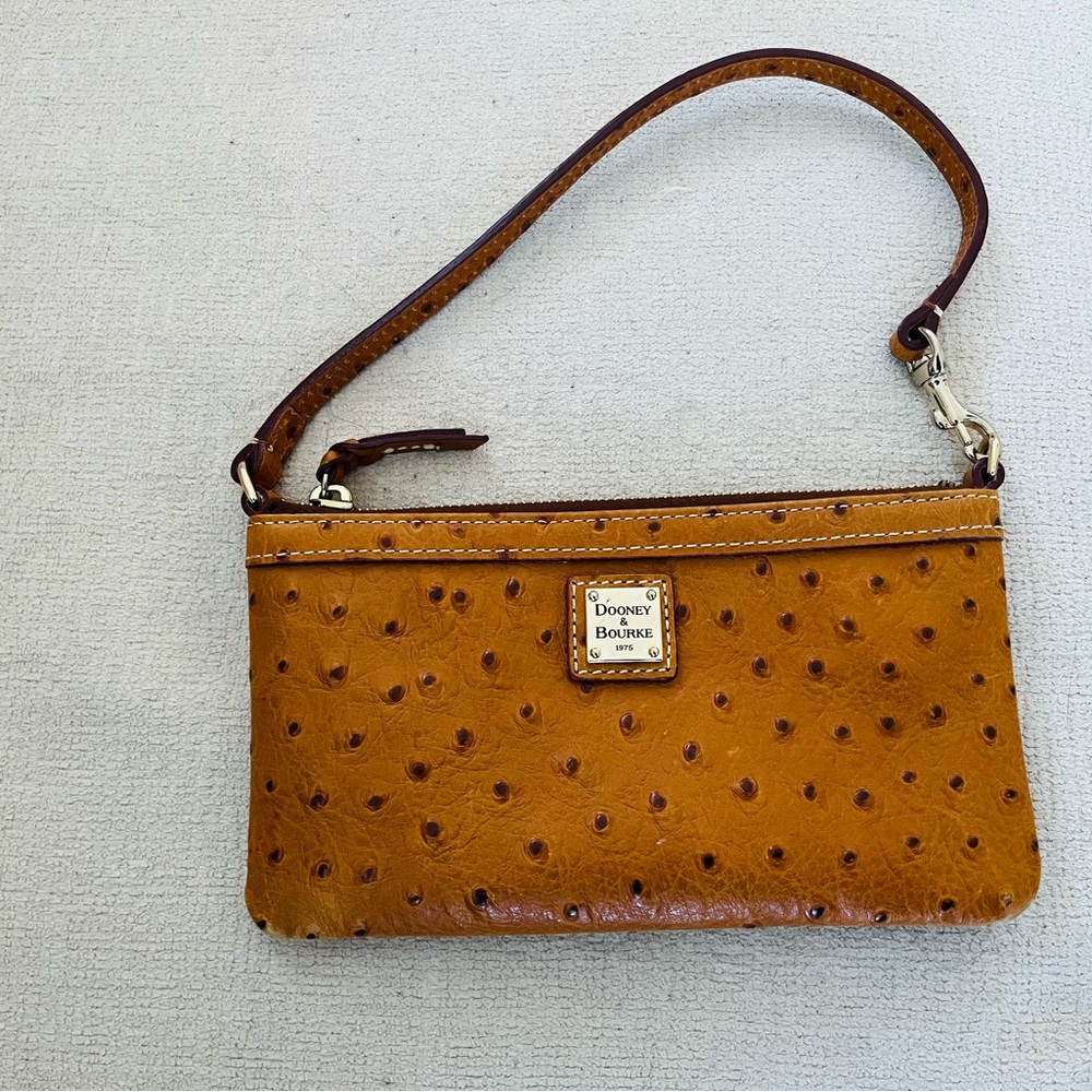 Rare Dooney and Bourke pebble leather clutch with strap